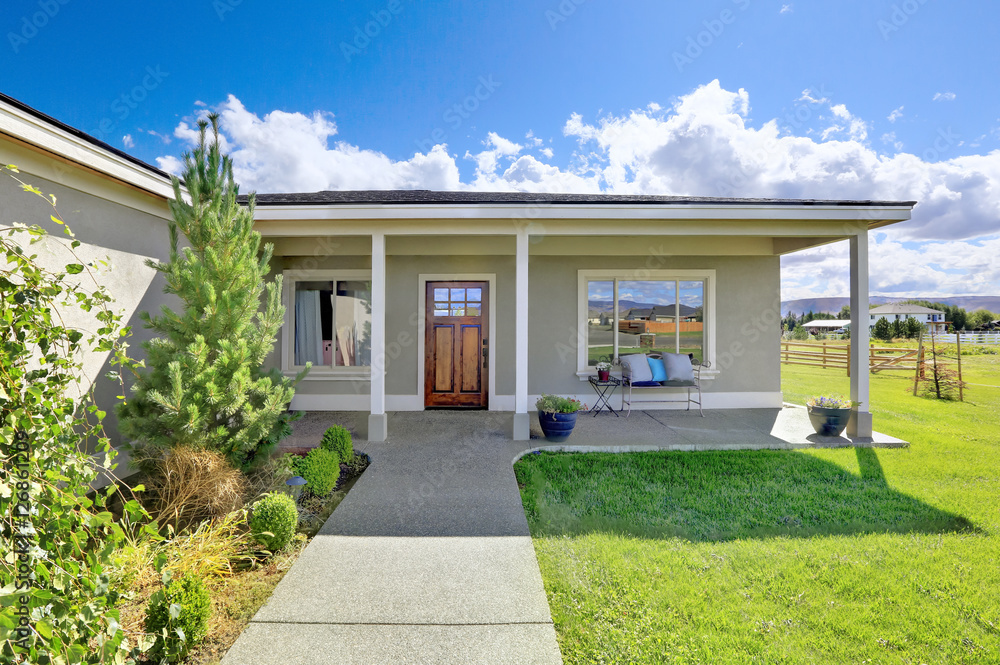 Covered entrance porch with concrete floor and columns