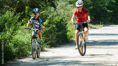 Mother and son mountain biking