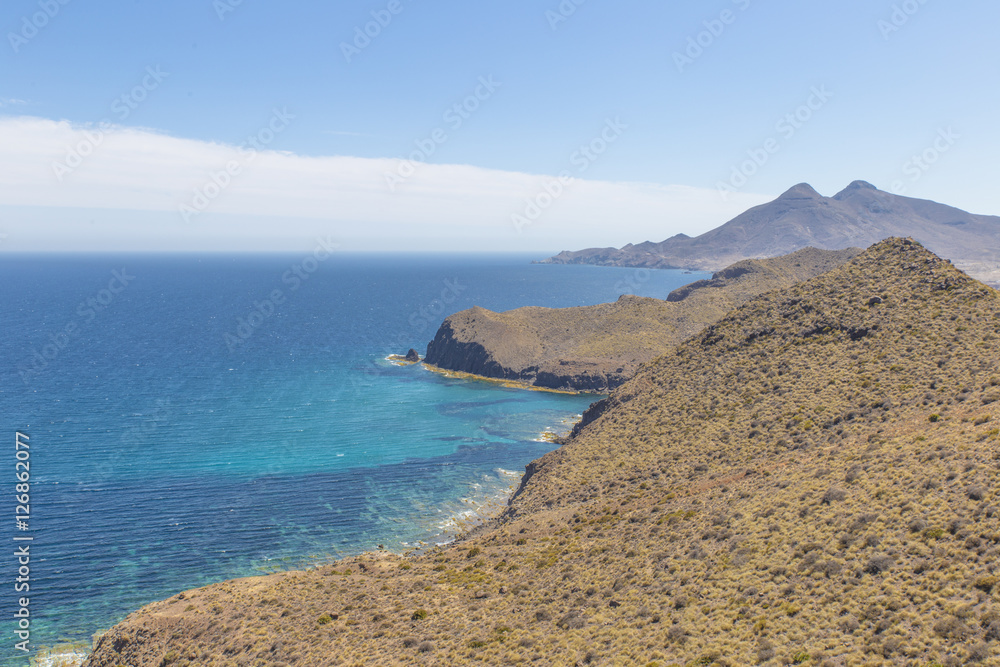 Fototapeta premium Beautiful landscape seen from La Amatista viewpoint in Cabo de Gata Nijar Natural Park, Almeria, Andalusia, Spain. beauty coastscape of Mountains at Mediterranean sea in Protected area 