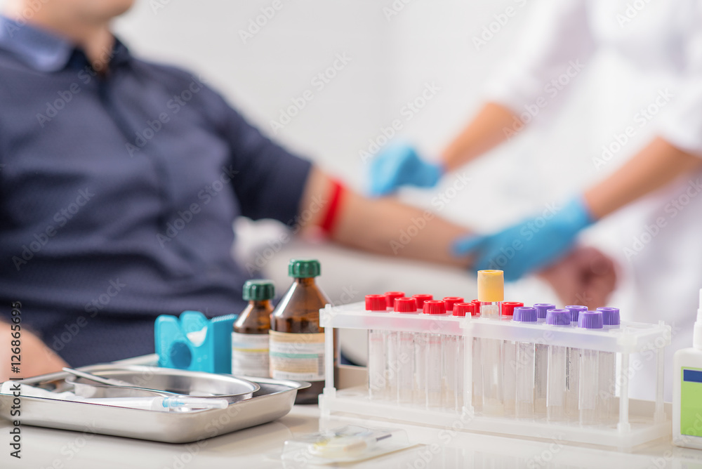 Man getting blood test preparation in clinic - obrazy, fototapety, plakaty 