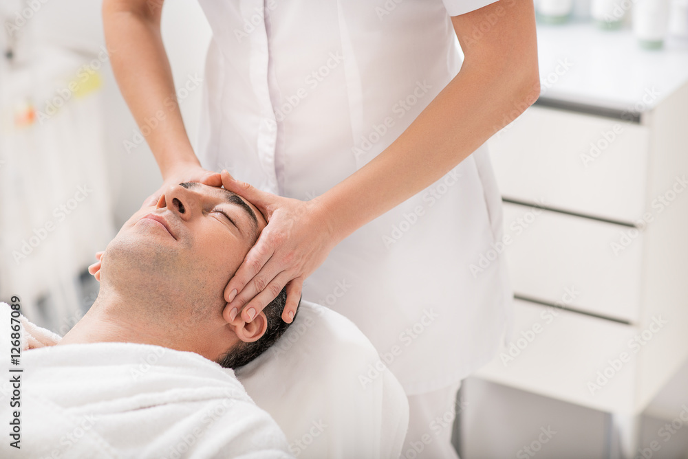 Businessman relaxing during massage at spa