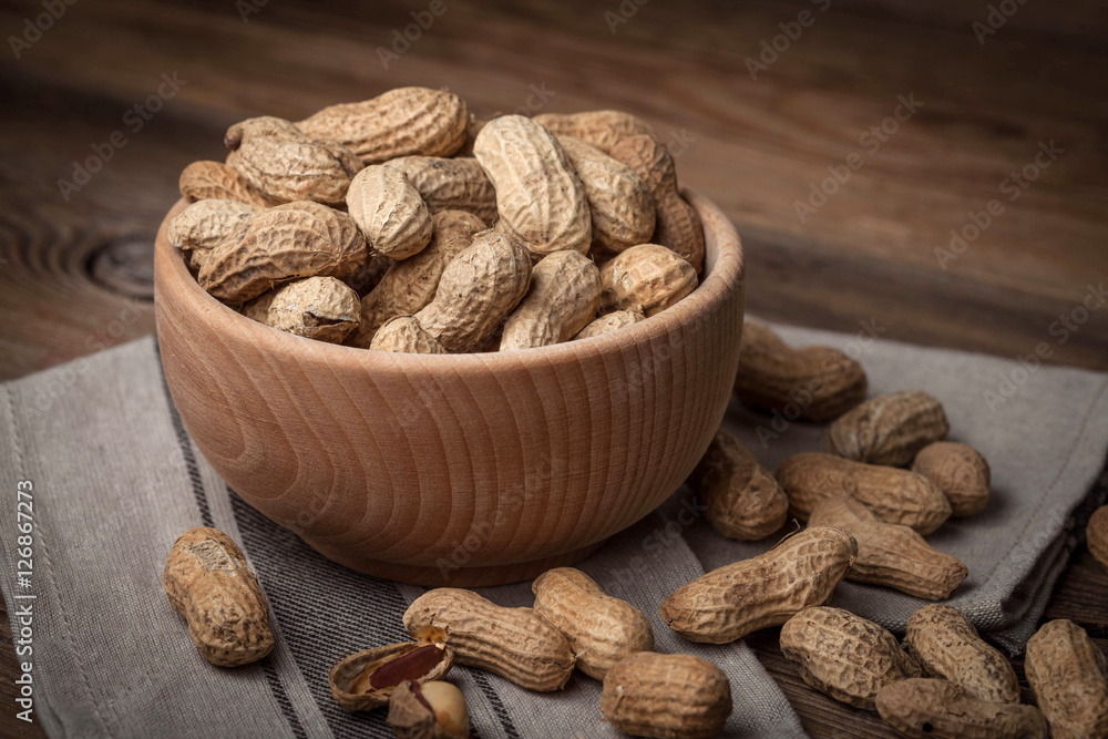 Dried peanuts in wooden bowl. Dried peanuts in wooden bowl.