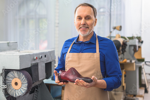 Tableau sur toile cobbler holding a brand new footwear