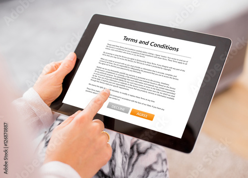 Person accepting terms and conditions on tablet photo
