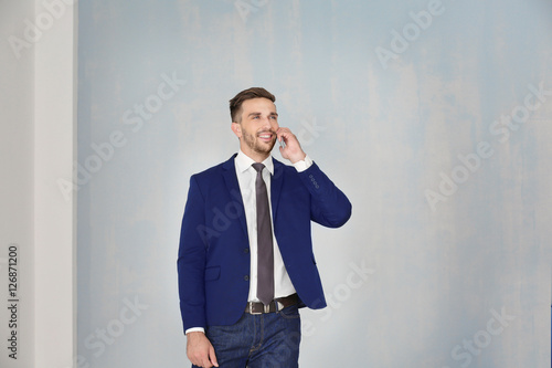 Young businessman with phon...