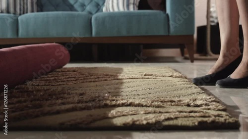 Saleswoman unfolding the carpet in slow motion