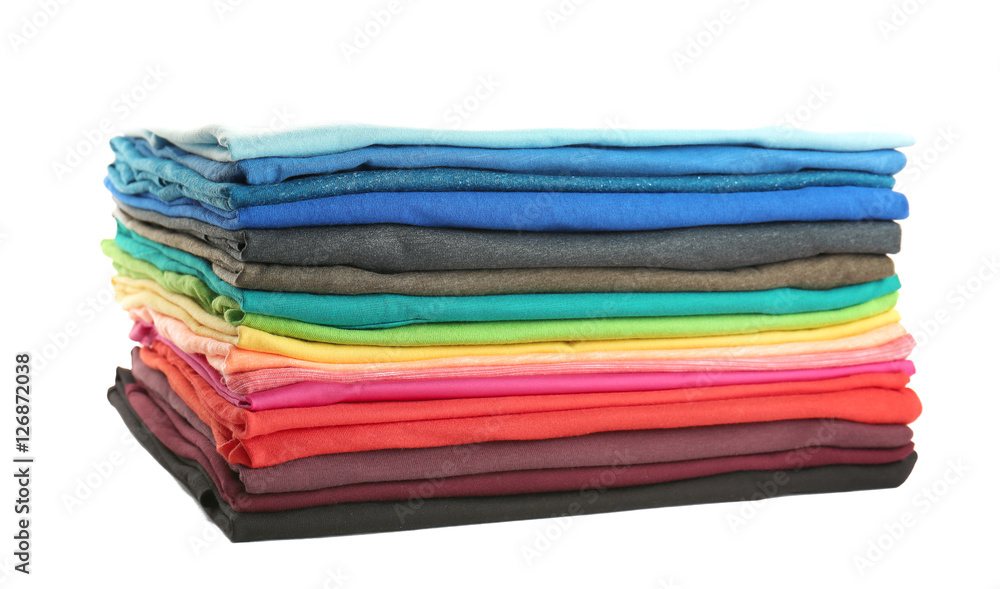 Stack of colorful t-shirts on white background, close up view Stack of colorful t-shirts on white background, close up view