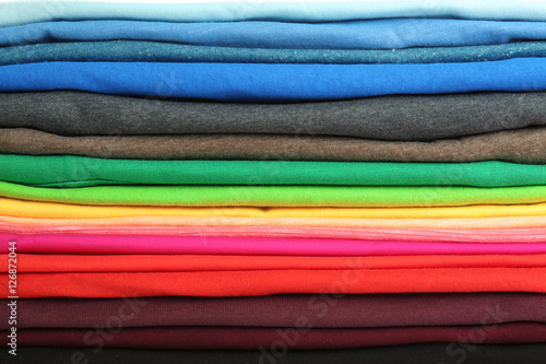 Stack of colorful t-shirts, close up view