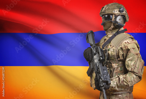 Soldier in helmet holding machine gun with flag on background series - Armenia
