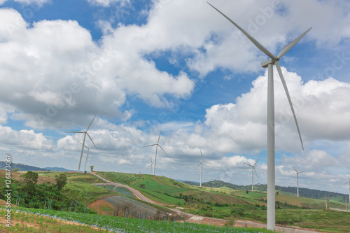 Huge wind turbine under clouds and blue sky  beautiful nature and Renewable power background