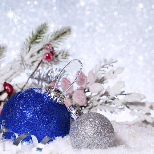 Blue Christmas ball in the snow. New Year composition.