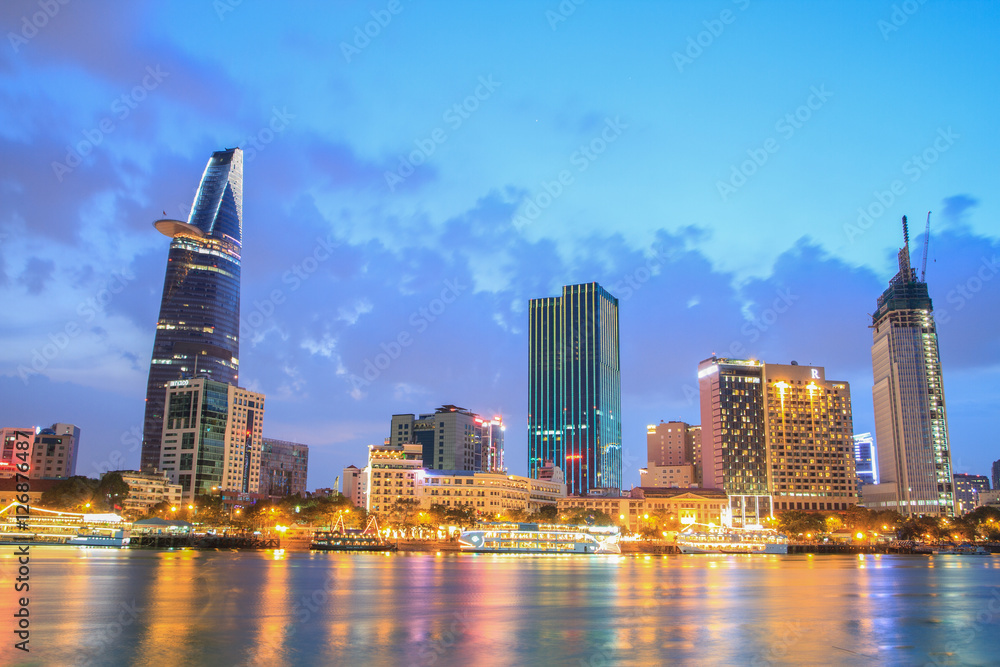 Night view of Downtown center of Ho Chi Minh city on Saigon riverbank in twilight, Vietnam