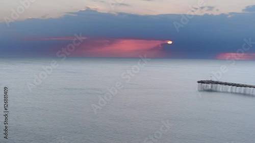 This video is about Ocean Sunrise Storm and Pier photo