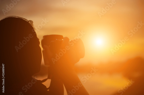 Women Nature photographer with digital camera on the mountain