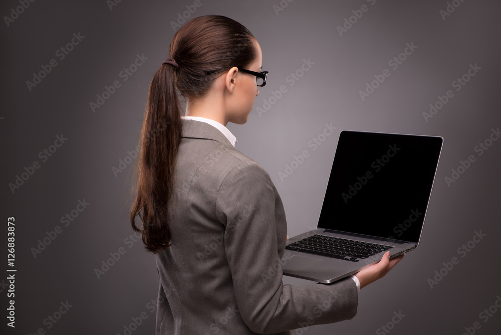 Young businesswoman working with laptop in business concept Young businesswoman working with laptop in business concept