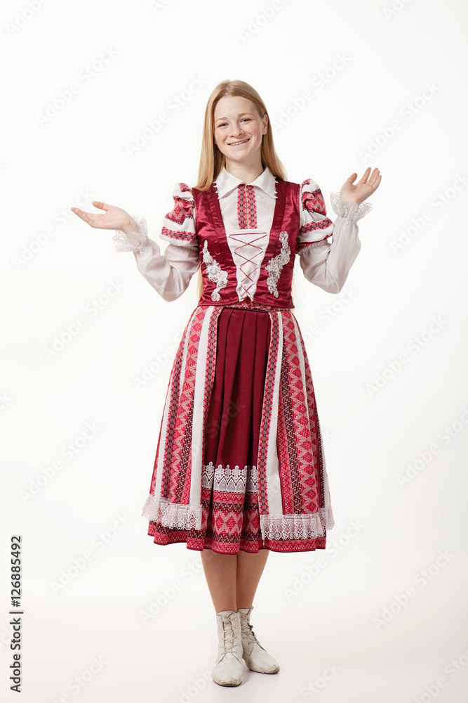 Young beautiful redhead woman dancer in traditional folk costume posing isolated on white background Young beautiful redhead woman dancer in traditional folk costume posing isolated on white background