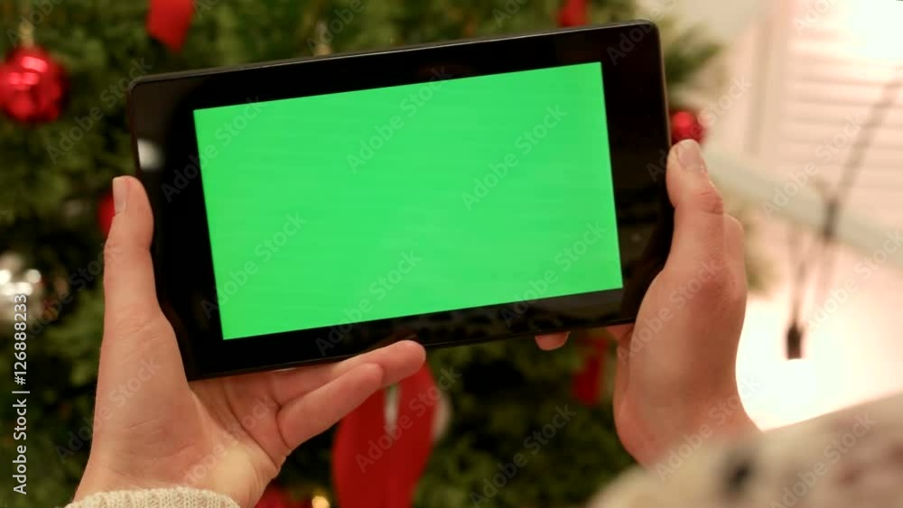 Close-up of female hands touching green screen on tablet Green screen Chroma Key. Close up. Tracking motion. Vertical.with blur christmas decoration background Close-up of female hands touching green screen on tablet Green screen Chroma Key. Close up. Tracking motion. Vertical.with blur christmas decoration background