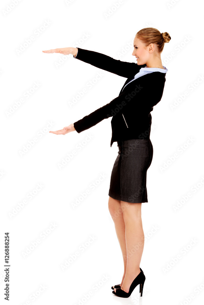 Business woman is having empty space between her hands Business woman is having empty space between her hands