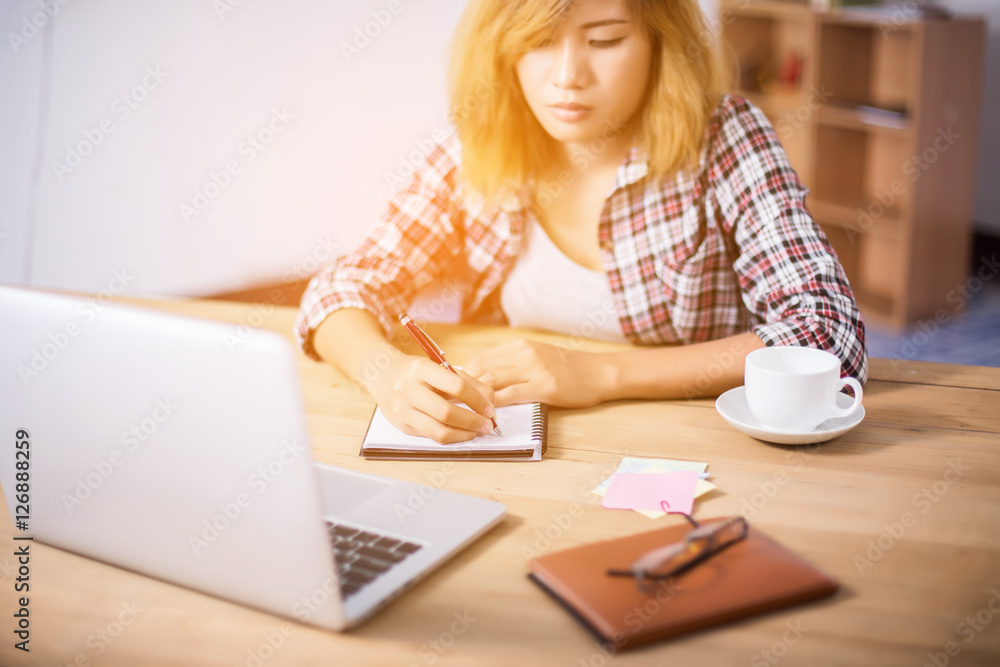 Business Woman Writing with pen in notepad on workplace. Business Woman Writing with pen in notepad on workplace.