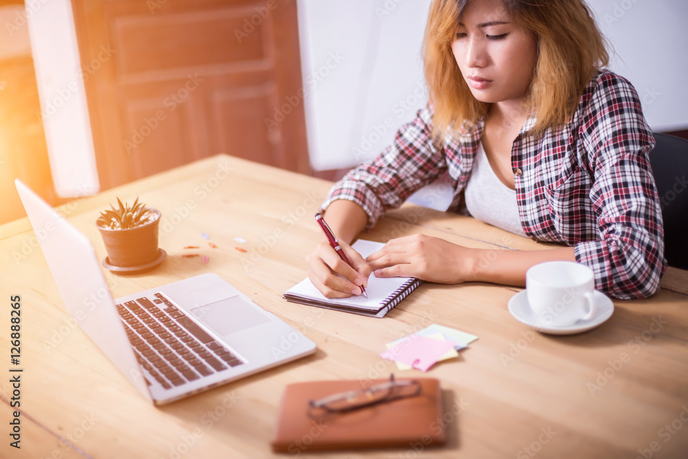 Business Woman Writing with pen in notepad on workplace. Business Woman Writing with pen in notepad on workplace.