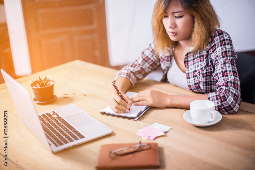 Business Woman Writing with pen in notepad on workplace. Business Woman Writing with pen in notepad on workplace.
