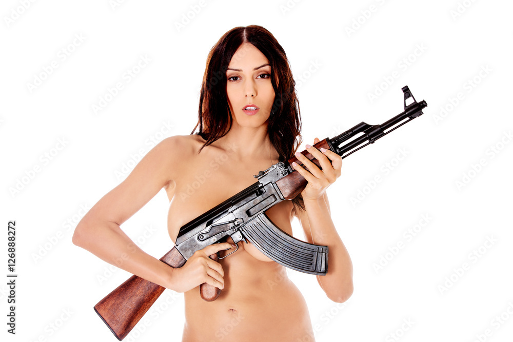Sexy nude brunette girl model with weapon.