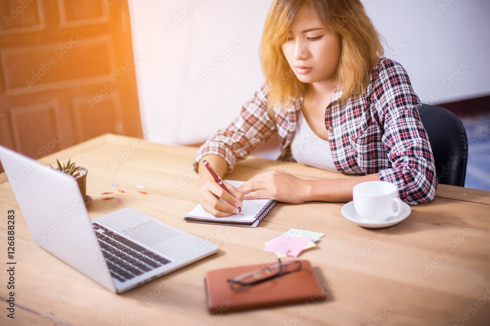 Business Woman Writing with pen in notepad on workplace. Business Woman Writing with pen in notepad on workplace.