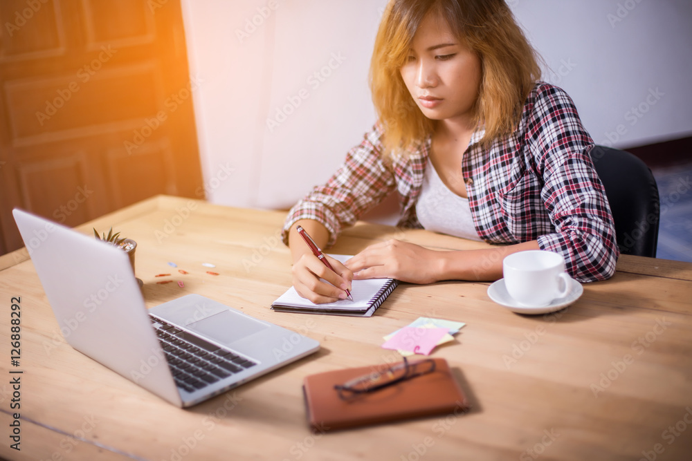 Business Woman Writing with pen in notepad on workplace. Business Woman Writing with pen in notepad on workplace.