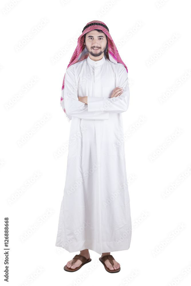 Arabic person smiling and standing in studio Arabic person smiling and standing in studio