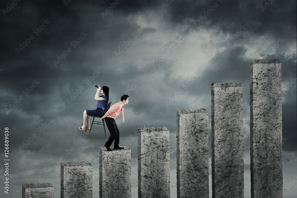 Businessman carrying his partner with business graph Businessman carrying his partner with business graph