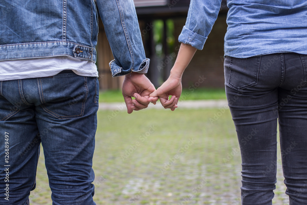 A young couple holding hands. In Nature sunrise A young couple holding hands. In Nature sunrise