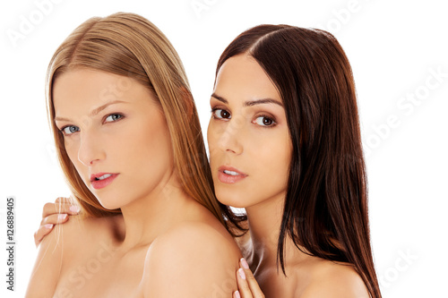 Beauty portrait of a two beautiful young women  studio white