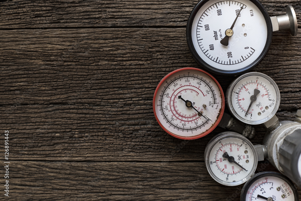 Old pressure gauge on wood table Old pressure gauge on wood table