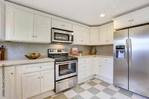 White kitchen storage combination, backsplash and tile floor