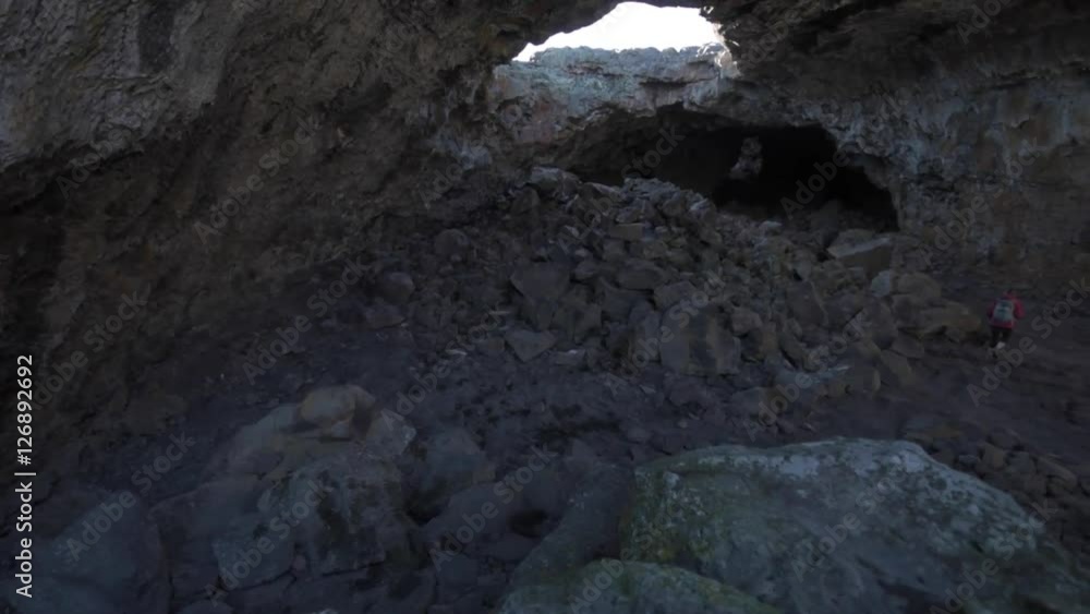 Young Woman exploring Indian Tunnel Cave Crater of the Moon National Preserve Idaho USA Young Woman exploring Indian Tunnel Cave Crater of the Moon National Preserve Idaho USA