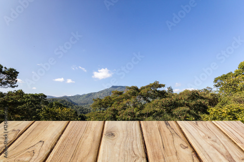 wood table with mountain and blue sky