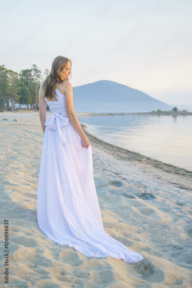 Beautiful girl walking on the beach.