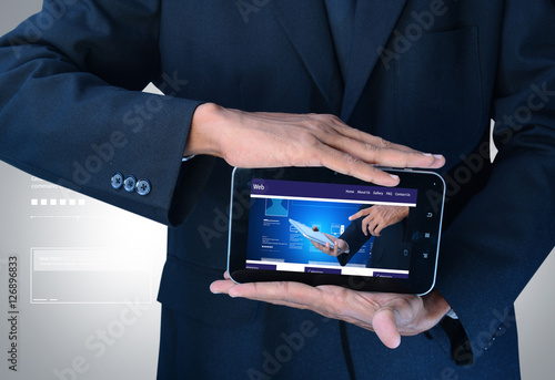 Fototapeta Naklejka Na Ścianę i Meble -  business man showing web page on tablet