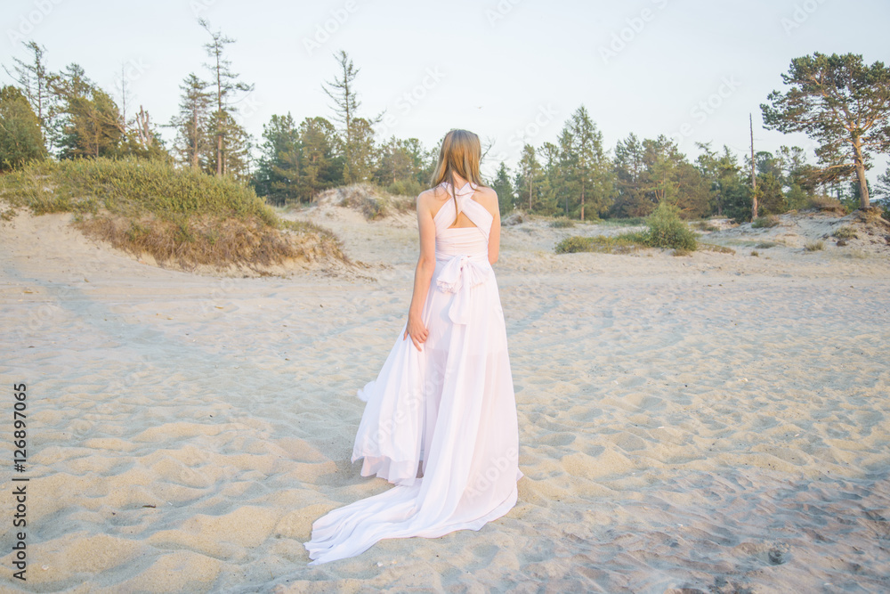 Beautiful girl walking on the beach.