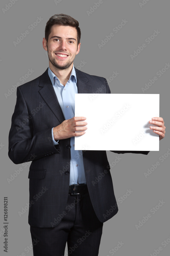 Portrait of a Man with a sign on a gray background Portrait of a Man with a sign on a gray background