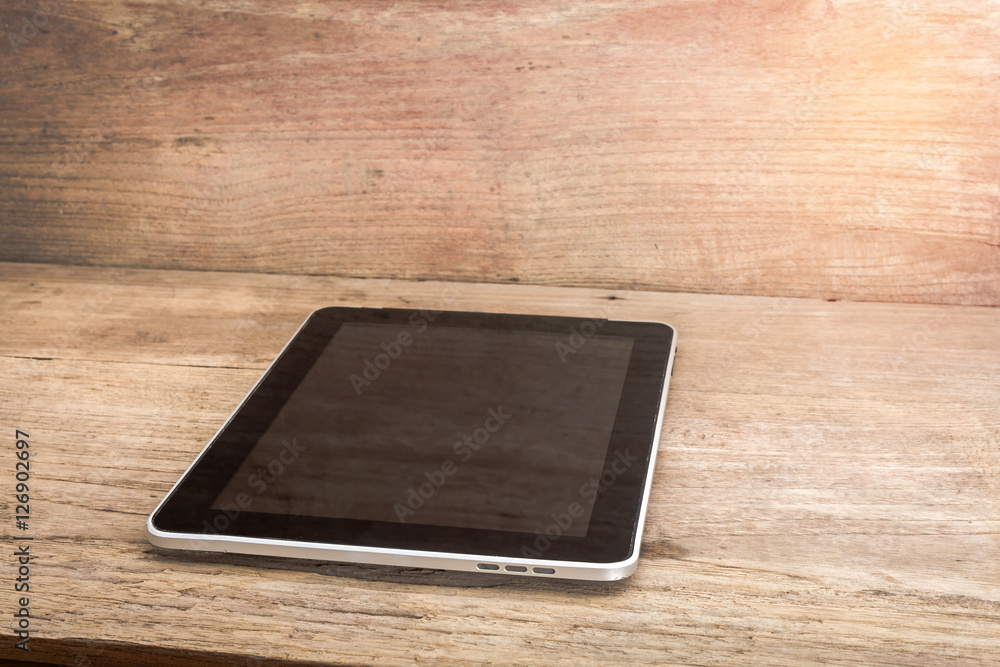 Image of a black digital tablet computer with white screen on ol Image of a black digital tablet computer with white screen on ol