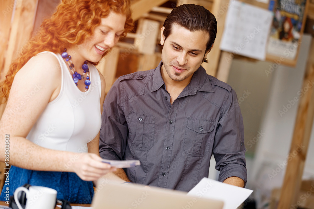Fototapeta premium Two young people in office