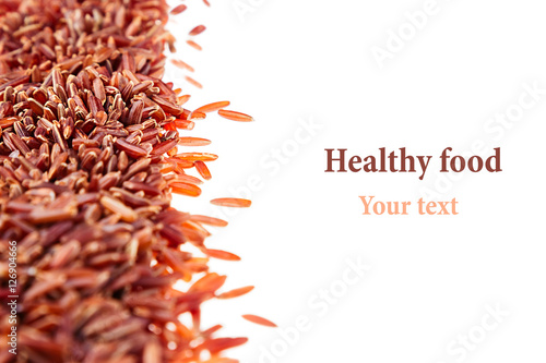 Fotografie Border of red rice close-up  on white background