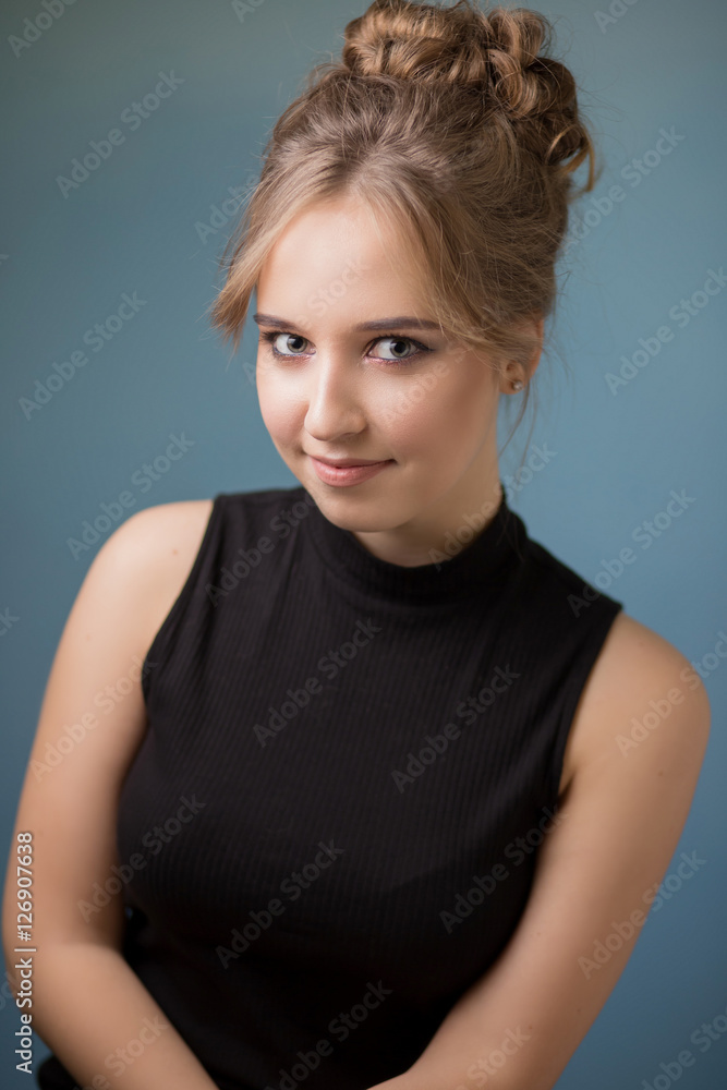 Beautiful girl with beautiful makeup, youth and skin care concept / photo of attractive blonde girl on blue background Beautiful girl with beautiful makeup, youth and skin care concept / photo of attractive blonde girl on blue background