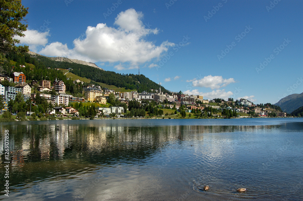 Cityscape of Saint Moritz with lake, blue sky and clouds. Engadin, Switzerland, Europe