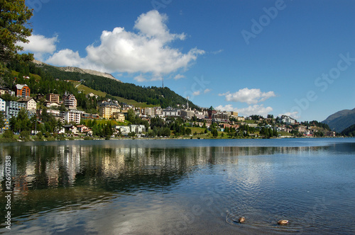 Cityscape of Saint Moritz with lake, blue sky and clouds. Engadin, Switzerland, Europe