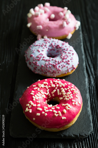 Three multi-colored donut