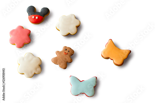 Small cookies with glaze. Biscuits in shape of butterflies. Crispy dough and sugar icing. Variety of tastes and colors.