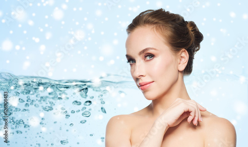 beautiful young woman face over water and snow