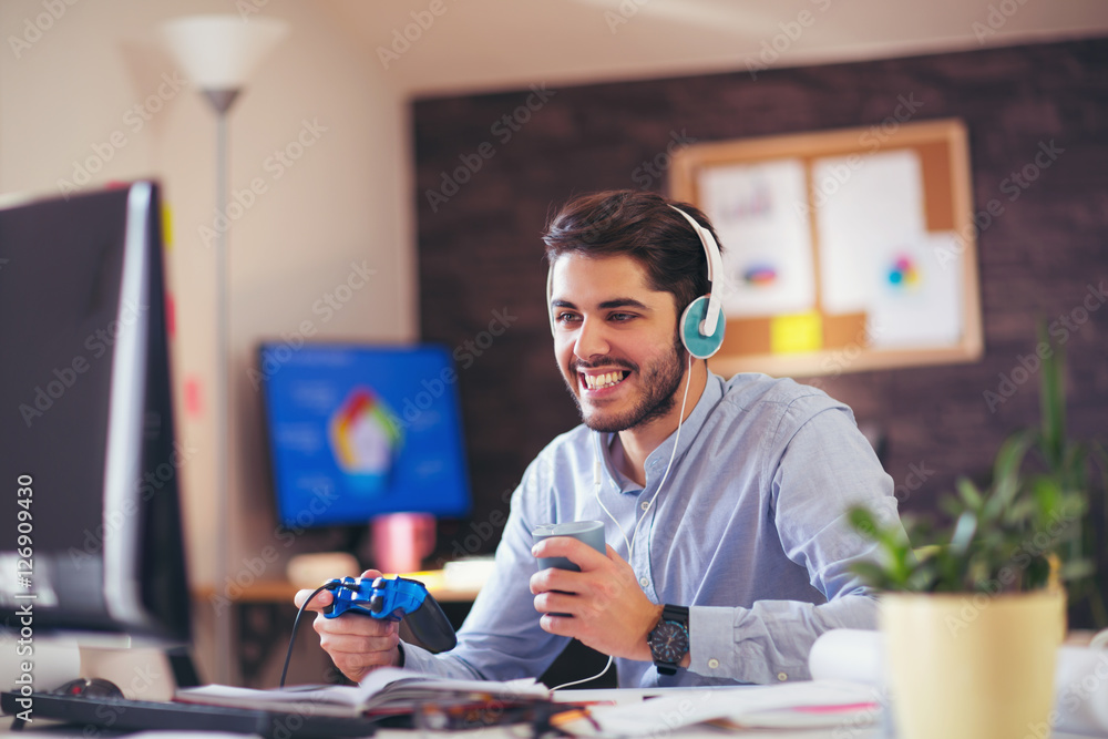 Fototapeta premium Businessman playing videogames in his office